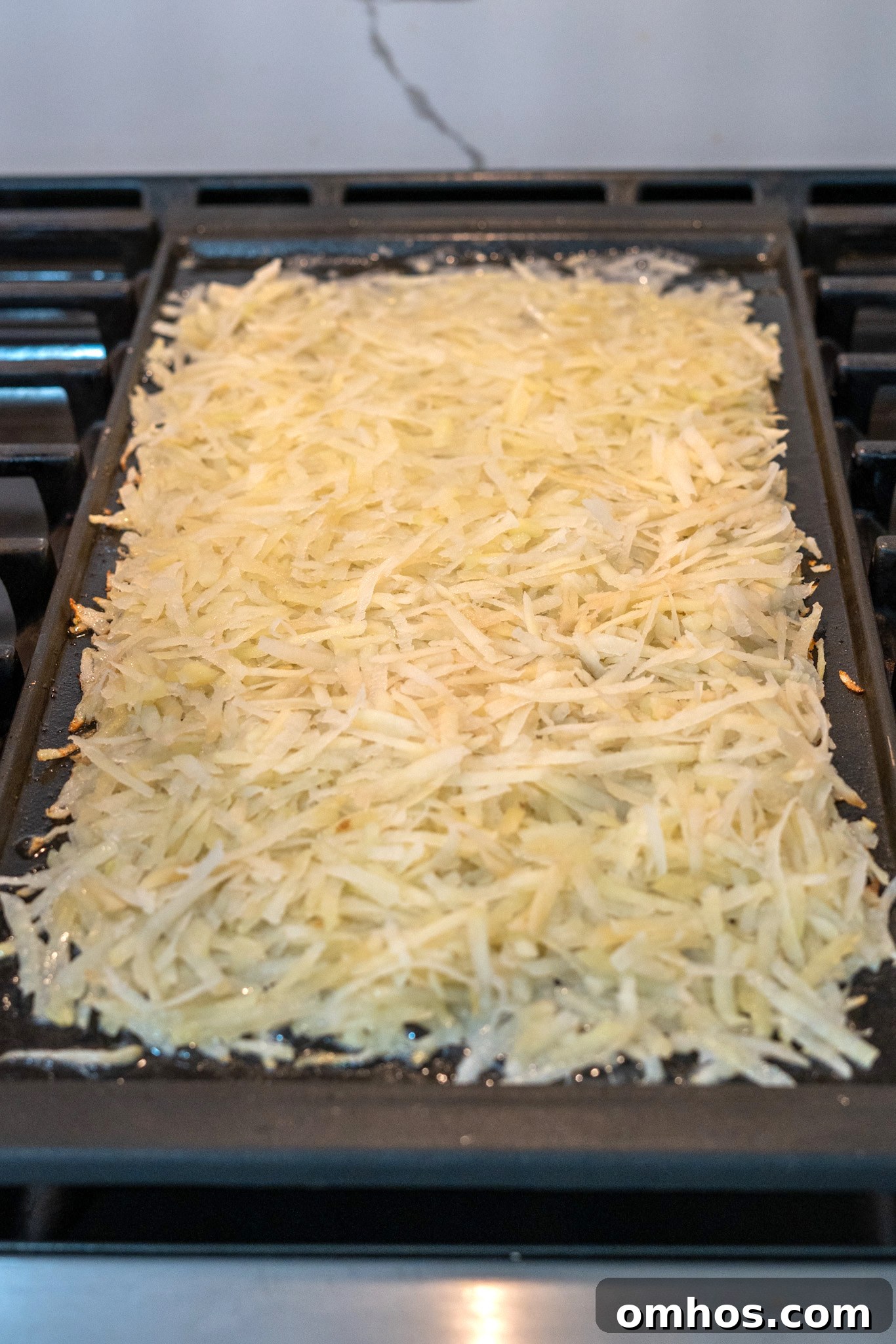 Homemade Crispy Hash Browns Recipe 8 Potatoes frying in a skillet