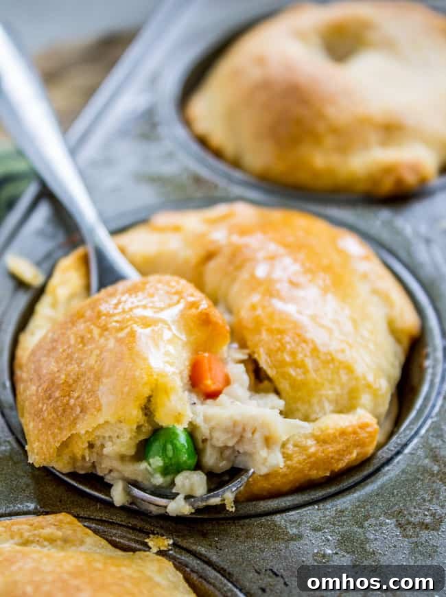 Serving up a mini chicken pot pie from a muffin tin.