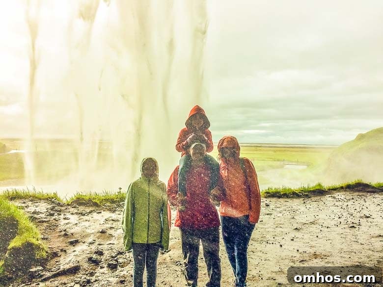 Iceland South Coast and Golden Circle: Day Trip Itinerary 14 Family Under Seljalandsfoss Waterfall Iceland South Coast Golden Circle