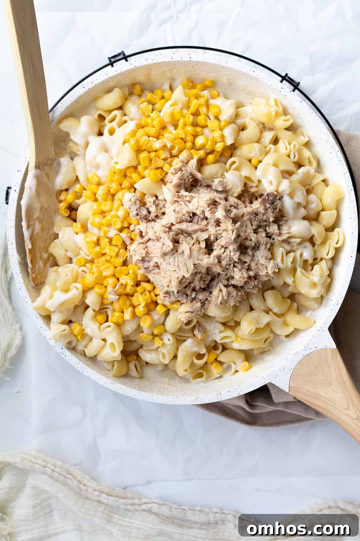Creamy 30 Minute Tuna and Sweetcorn Pasta Bake Recipe 5 tuna, sweetcorn and pasta being added to the white sauce
