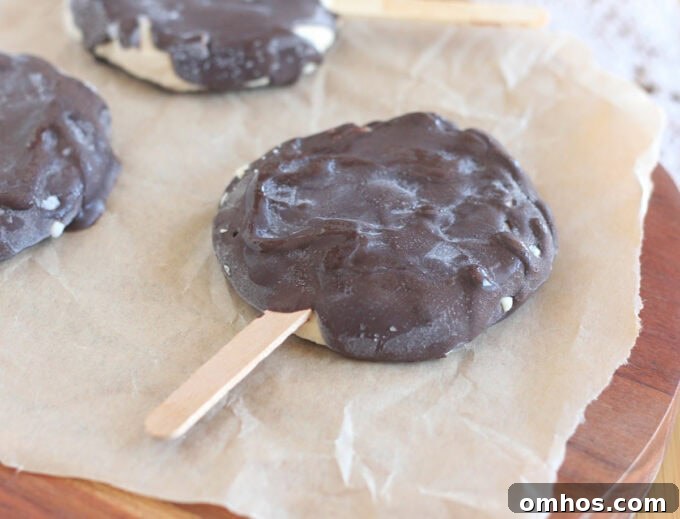 Homemade Dilly bar laying on a sheet of parchment paper.