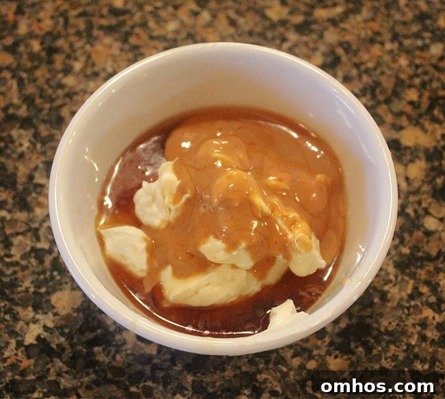 Yogurt, peanut butter, maple syrup, and vanilla in a bowl.