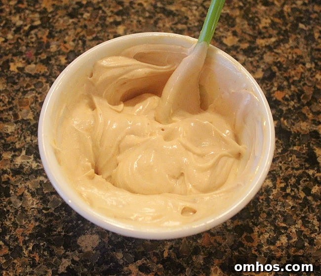 Greek yogurt mixed with peanut butter in a bowl.