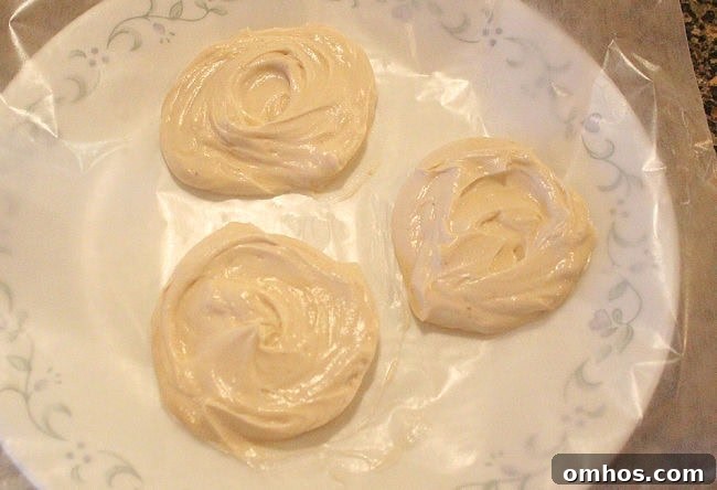 Dollops of Greek yogurt mixed with maple syrup on a wax papered plate.
