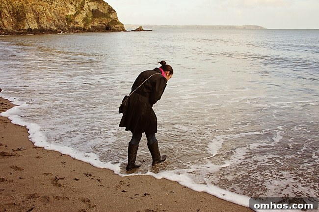 Child running toward the sea