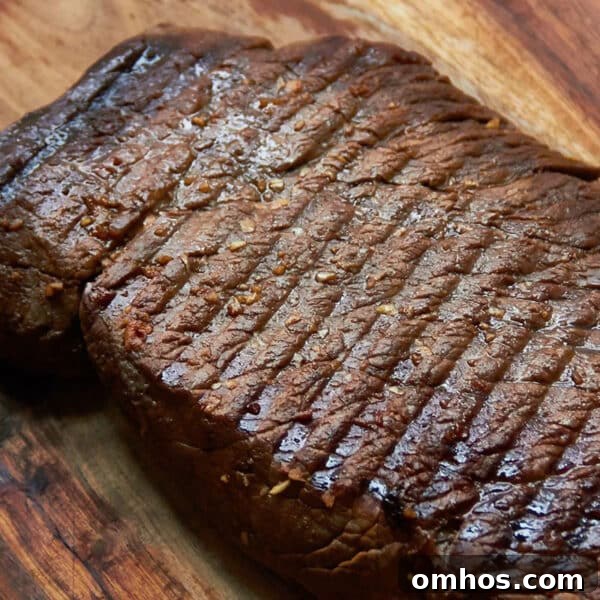 How to Achieve Perfect Crosshatch Grill Marks on Steak 4 Grilled Marinated London Broil resting on a wooden surface.