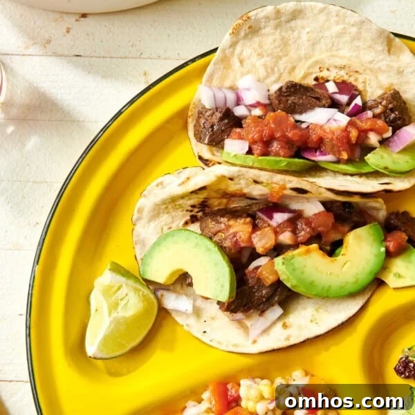 How to Achieve Perfect Crosshatch Grill Marks on Steak 6 Steak Street Tacos on yellow plate with avocado and other toppings.