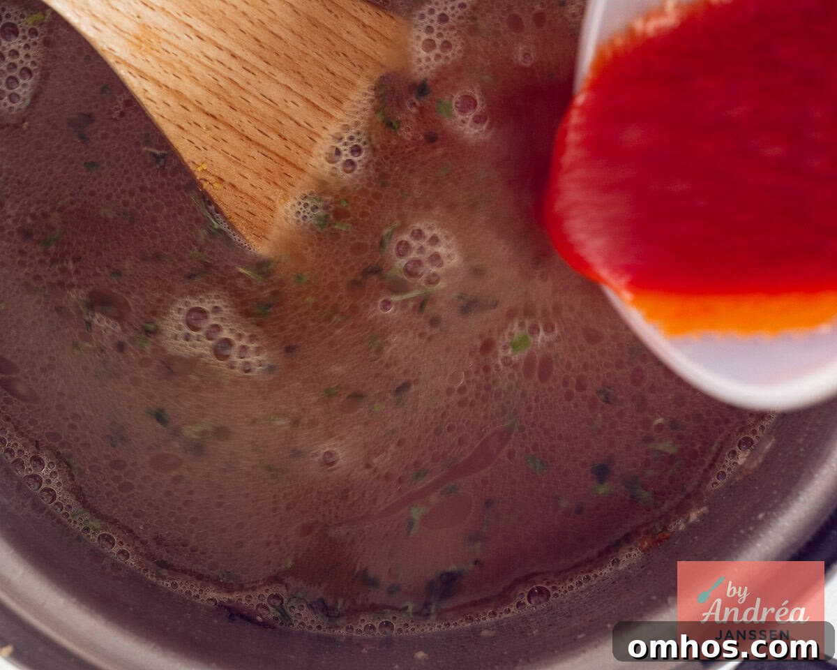 One-Pot Lasagna Soup Recipe for Cozy Weeknights 5 Add stock and sieved tomatoes to the pan.