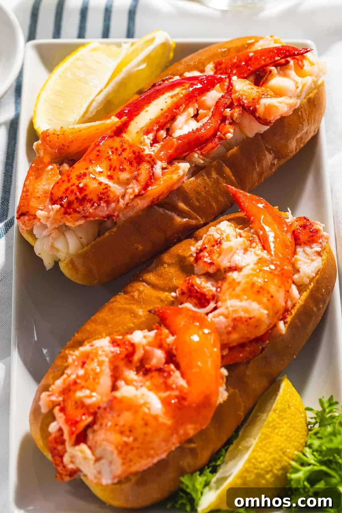 Warm Connecticut-Style Lobster Roll Recipe 3 Connecticut lobster roll with claw meat on a hot dog bun.