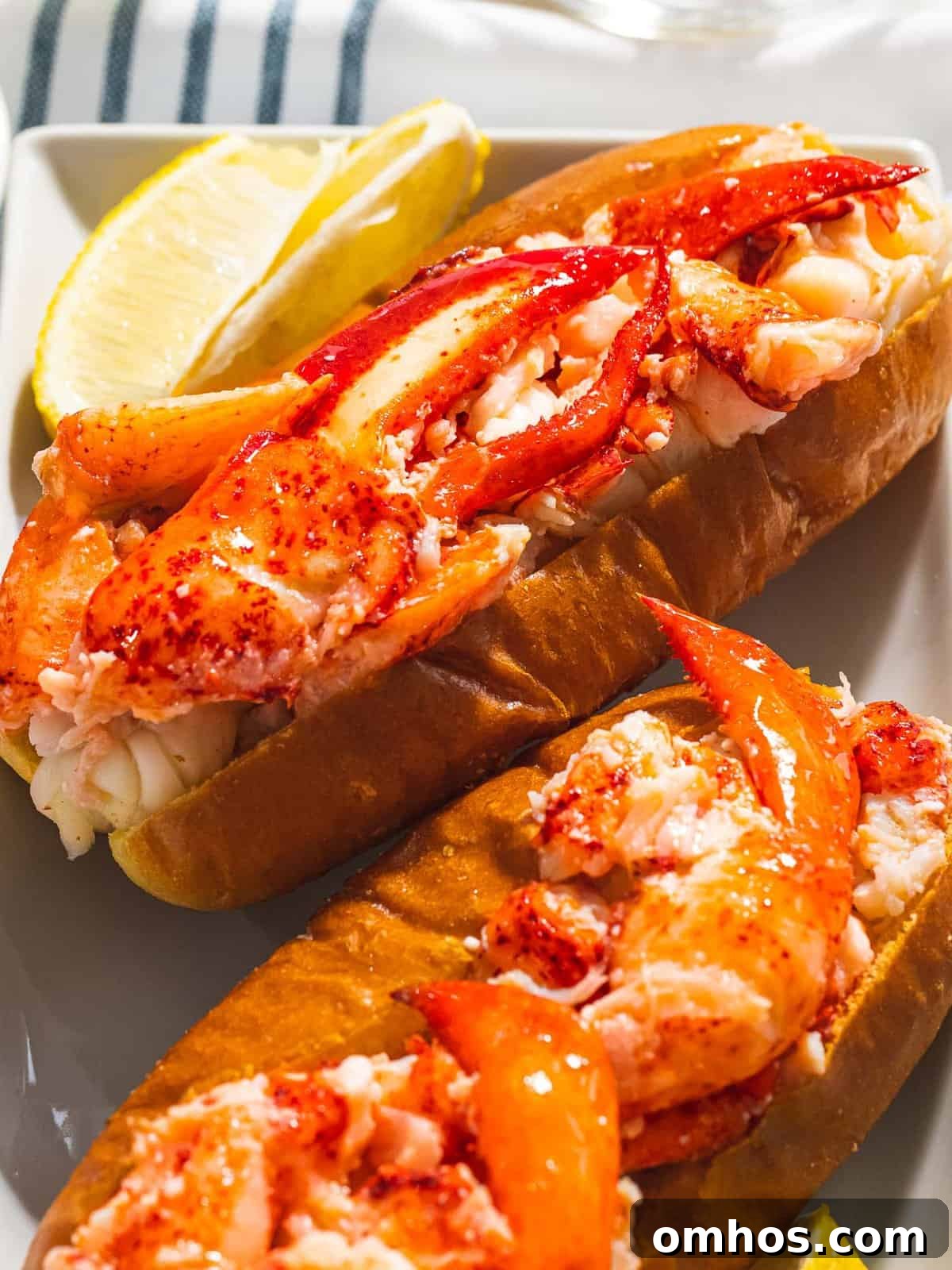 Warm Connecticut-Style Lobster Roll Recipe 7 Connecticut lobster roll with warm butter-covered lobster claw meat on a hot dog bun.