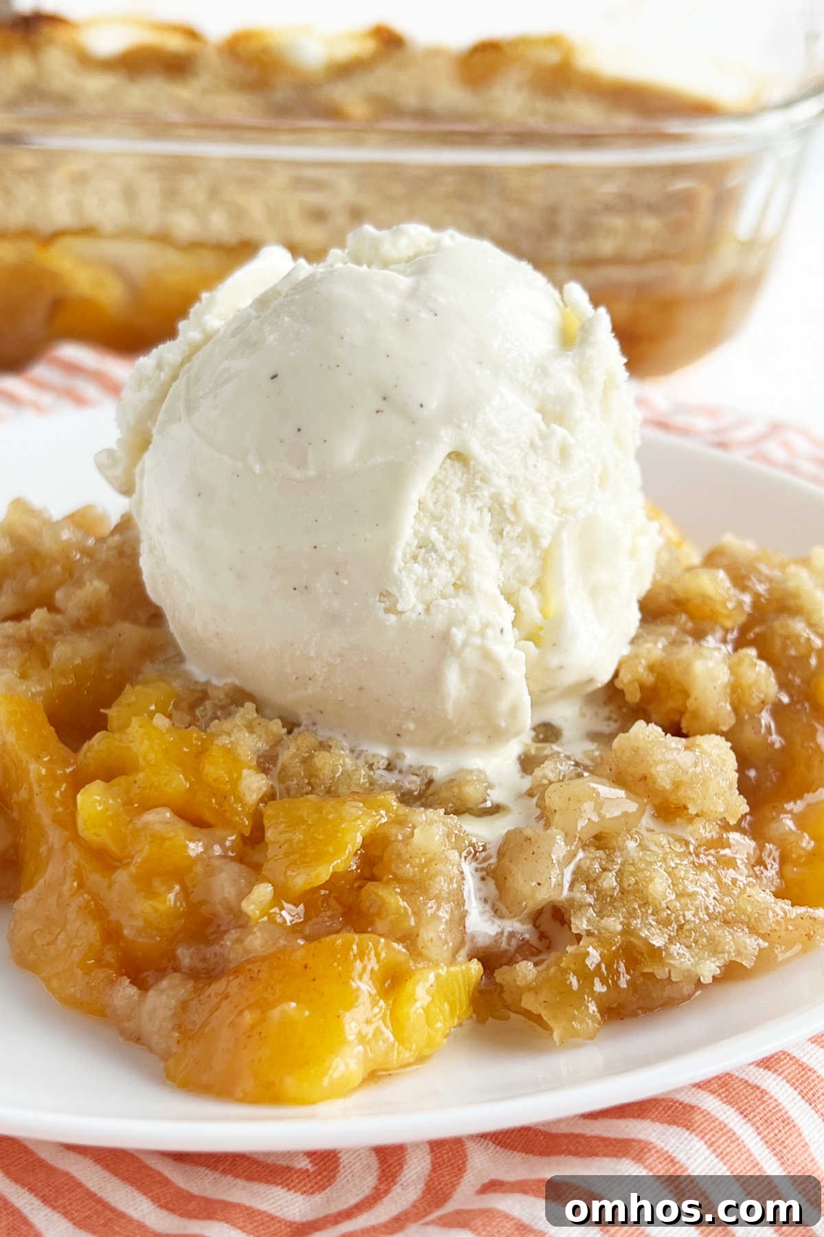 Homemade Fresh Peach Crisp Recipe with Oat Crumble 2 fresh peach crisp with scoop of vanilla ice cream on white plate