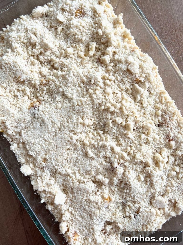 Homemade Fresh Peach Crisp Recipe with Oat Crumble 6 top peaches with crumble topping in baking dish