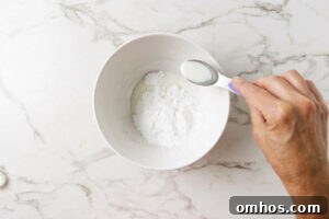 Making a sugar glaze for the tops of homemade muffins.