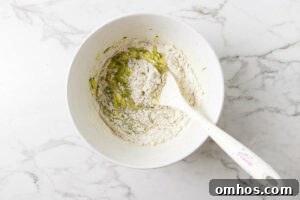 Folding the dry ingredients into muffin batter.