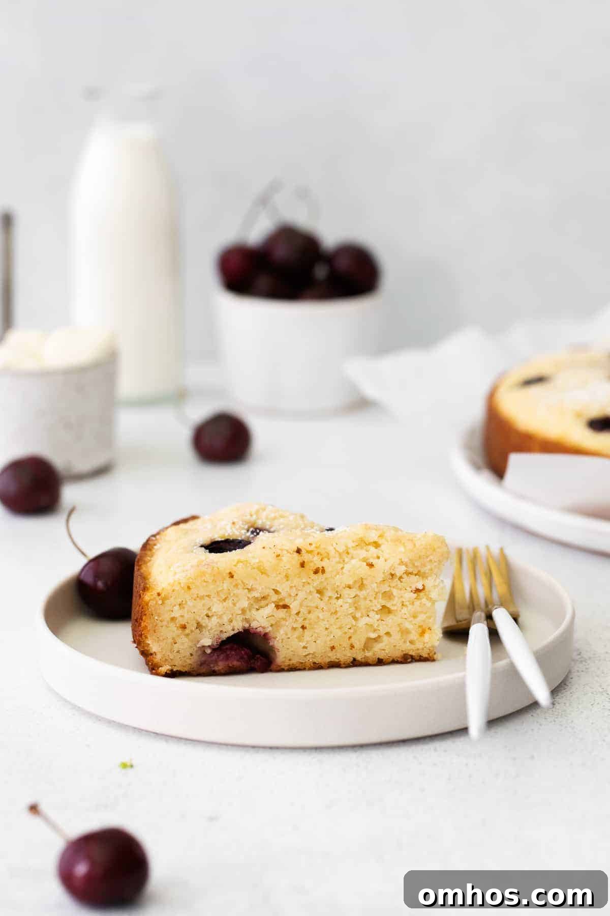 Slice of cherry ricotta cake on counter.