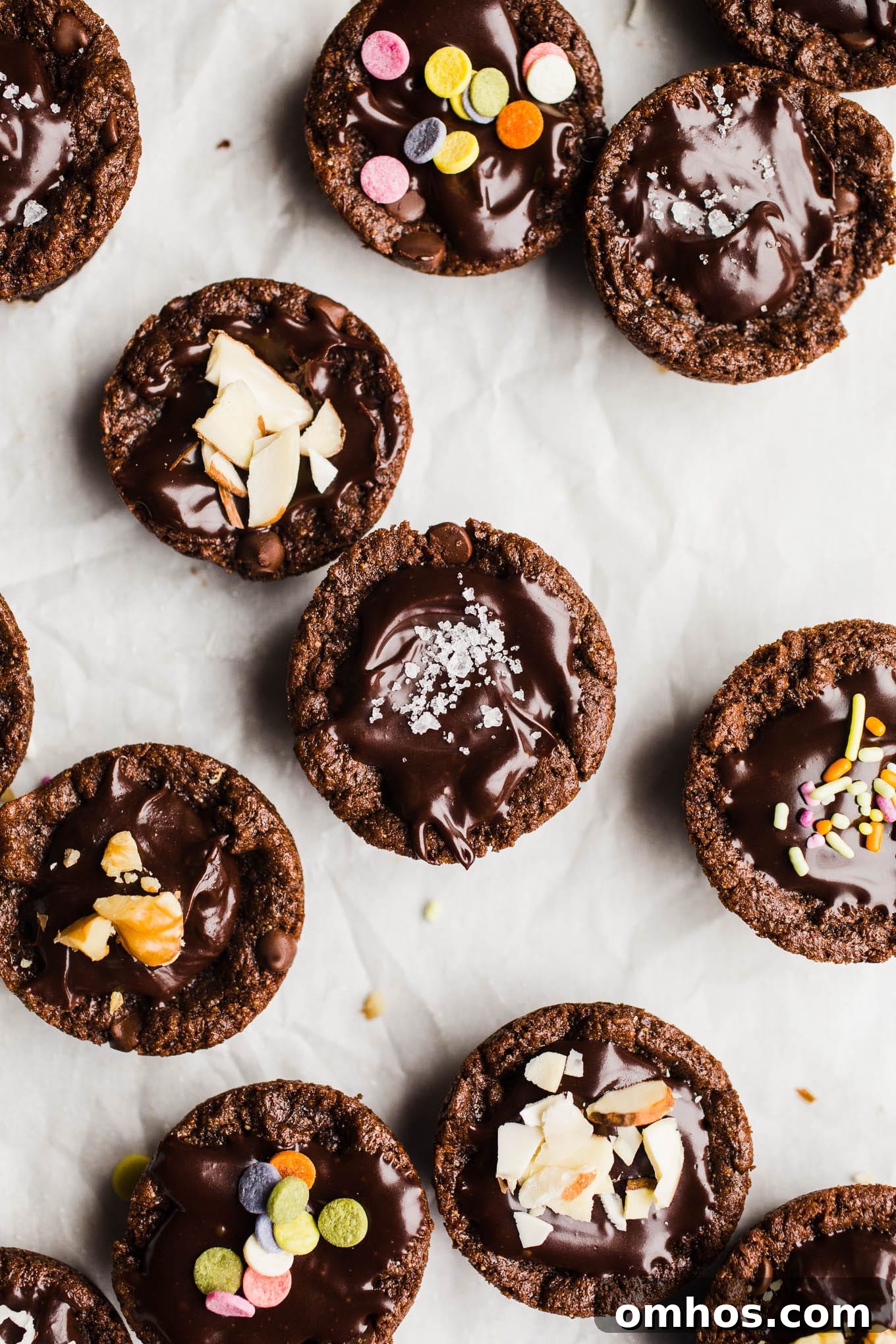 Small brownie bites topped with chocolate frosting.
