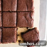 Frosted brownies on a piece of parchment paper.