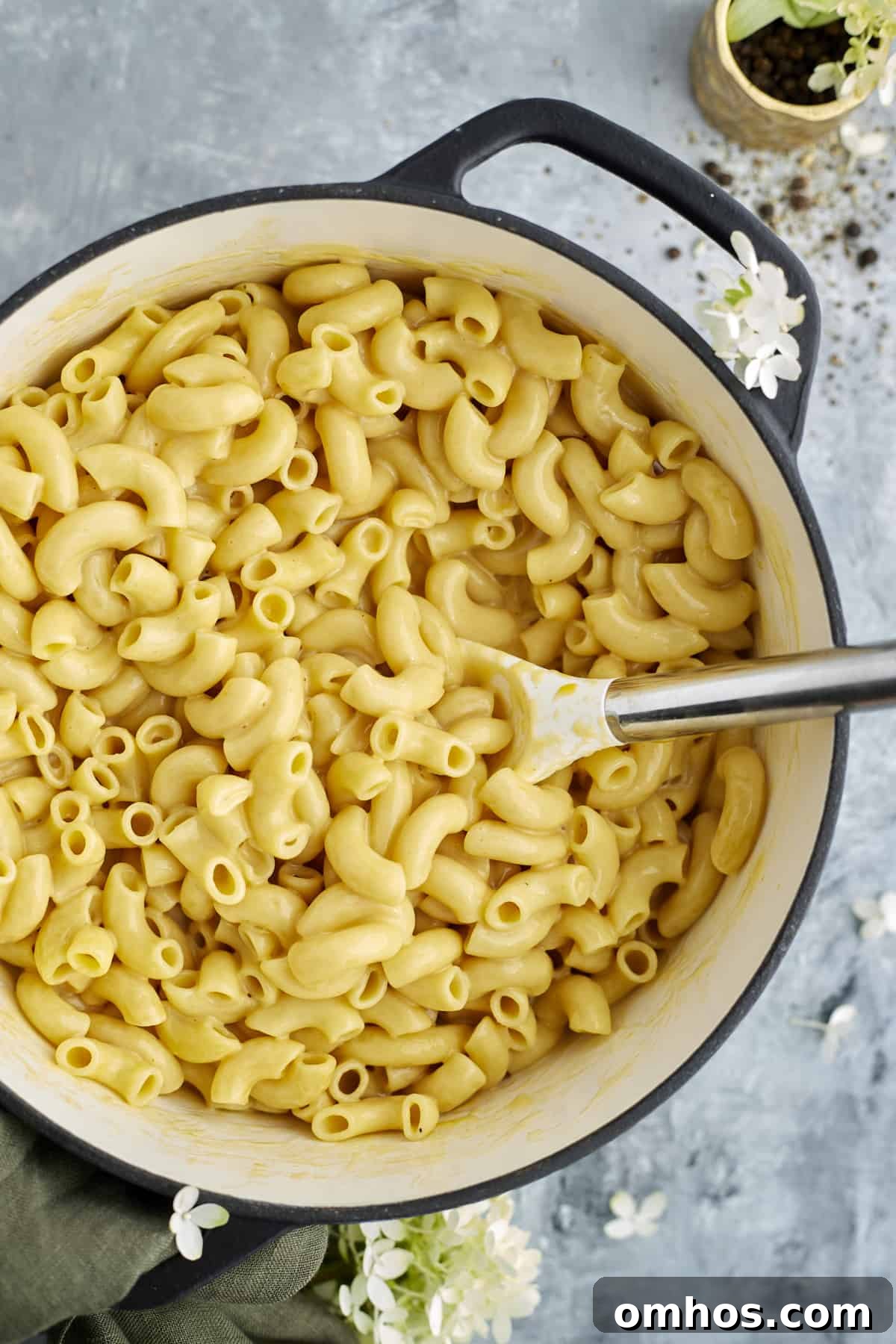 Quick Creamy One-Pot Mac and Cheese Recipe 4 overhead image of one pot mac and cheese in a large pot being stirred with a spoon