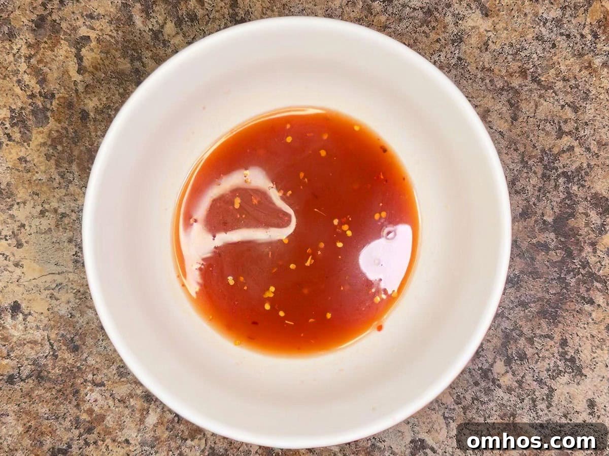 Sauce ingredients for slow cooker pork ribs mixed together in a small bowl.