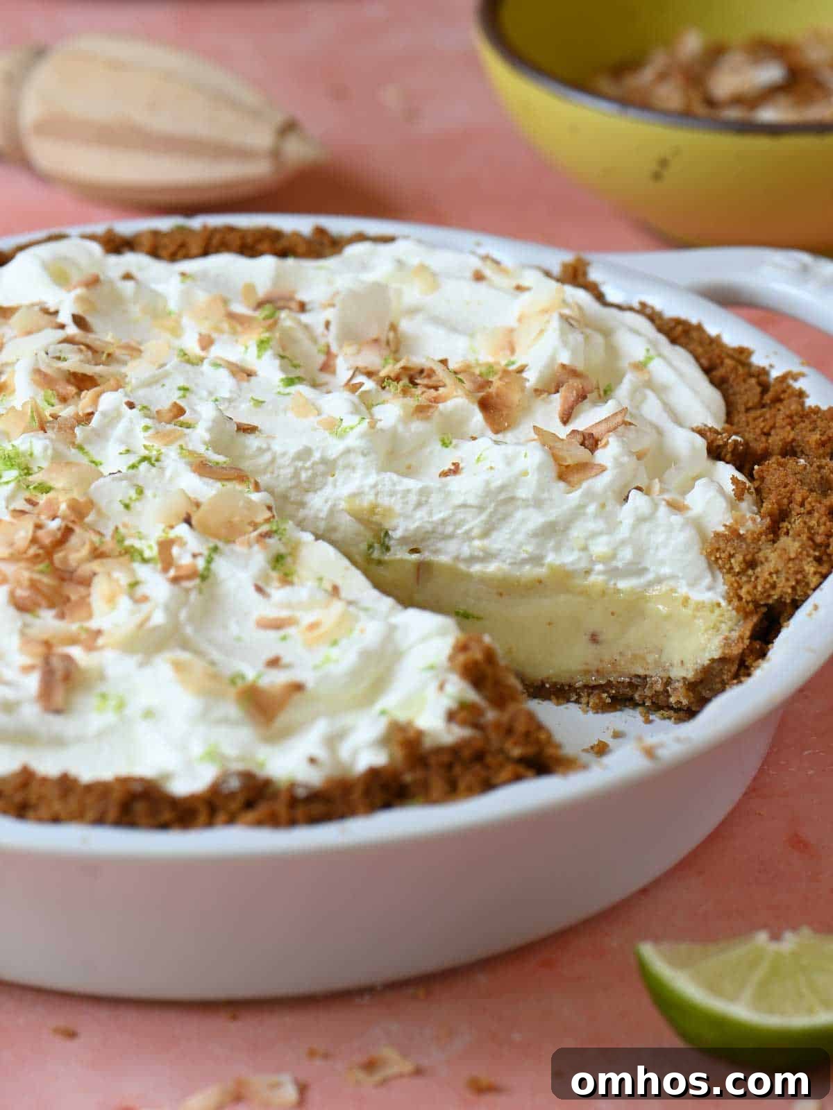 Key lime pie cut open in a pie plate to show the inside.