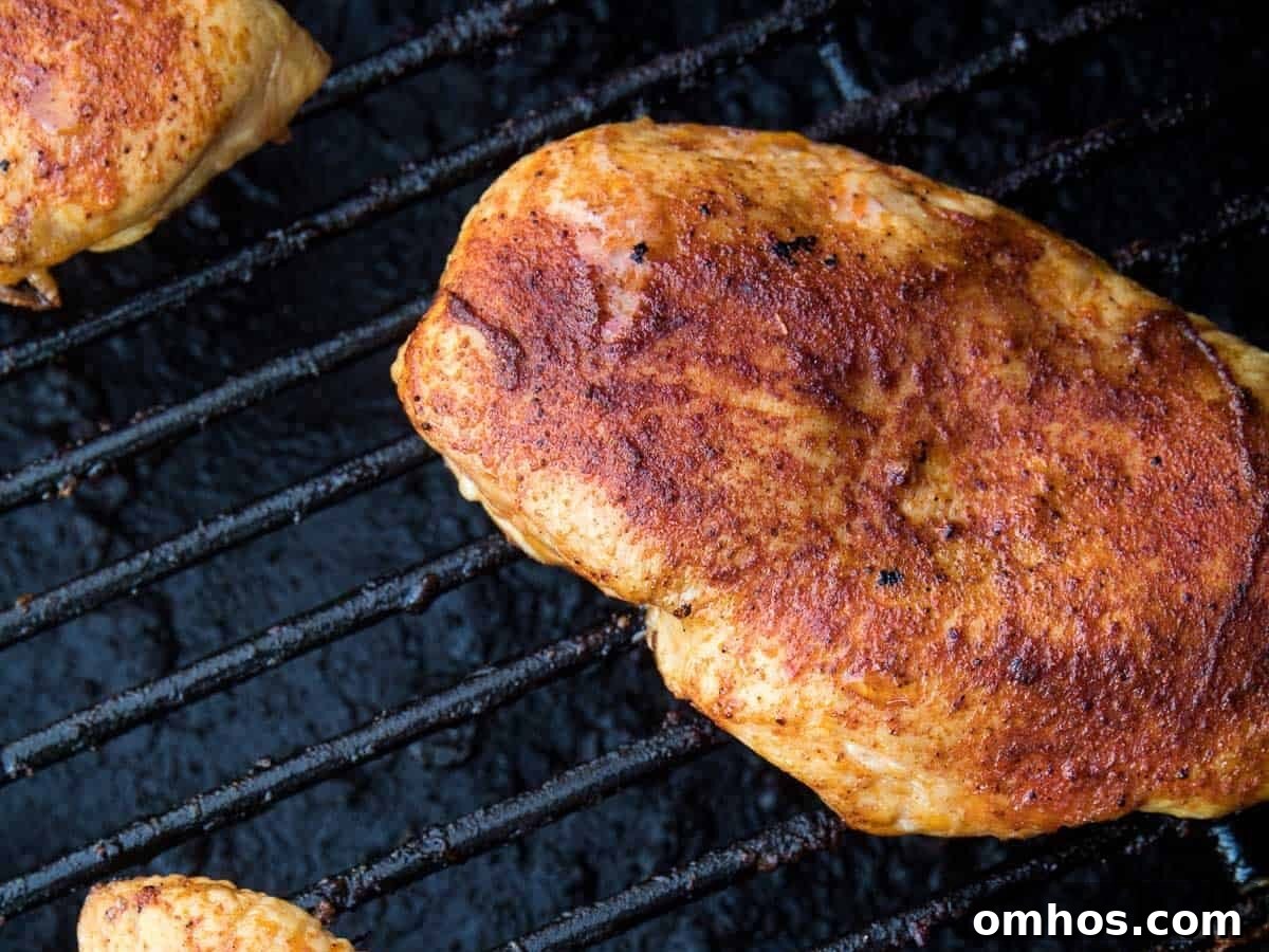 Seasoned chicken breasts on Traeger smoker