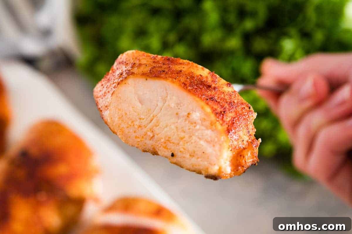 a fork with a piece of seasoned chicken breast