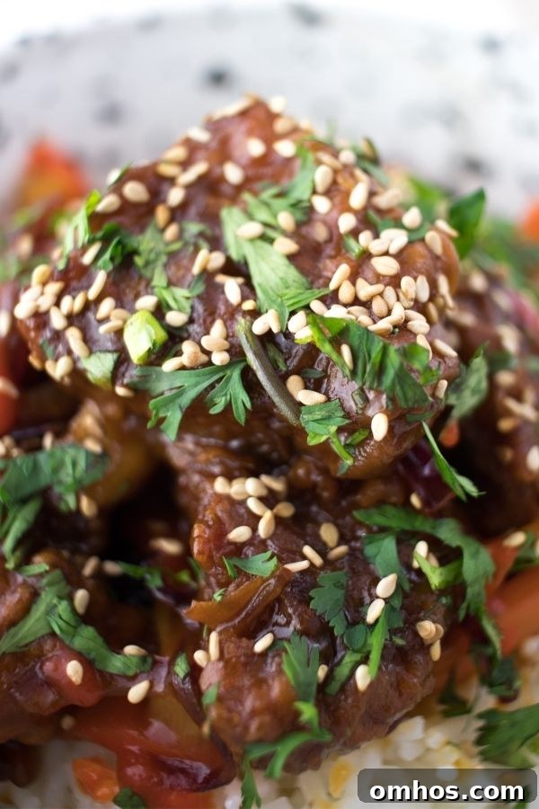 close up of sweet and sour pork on rice