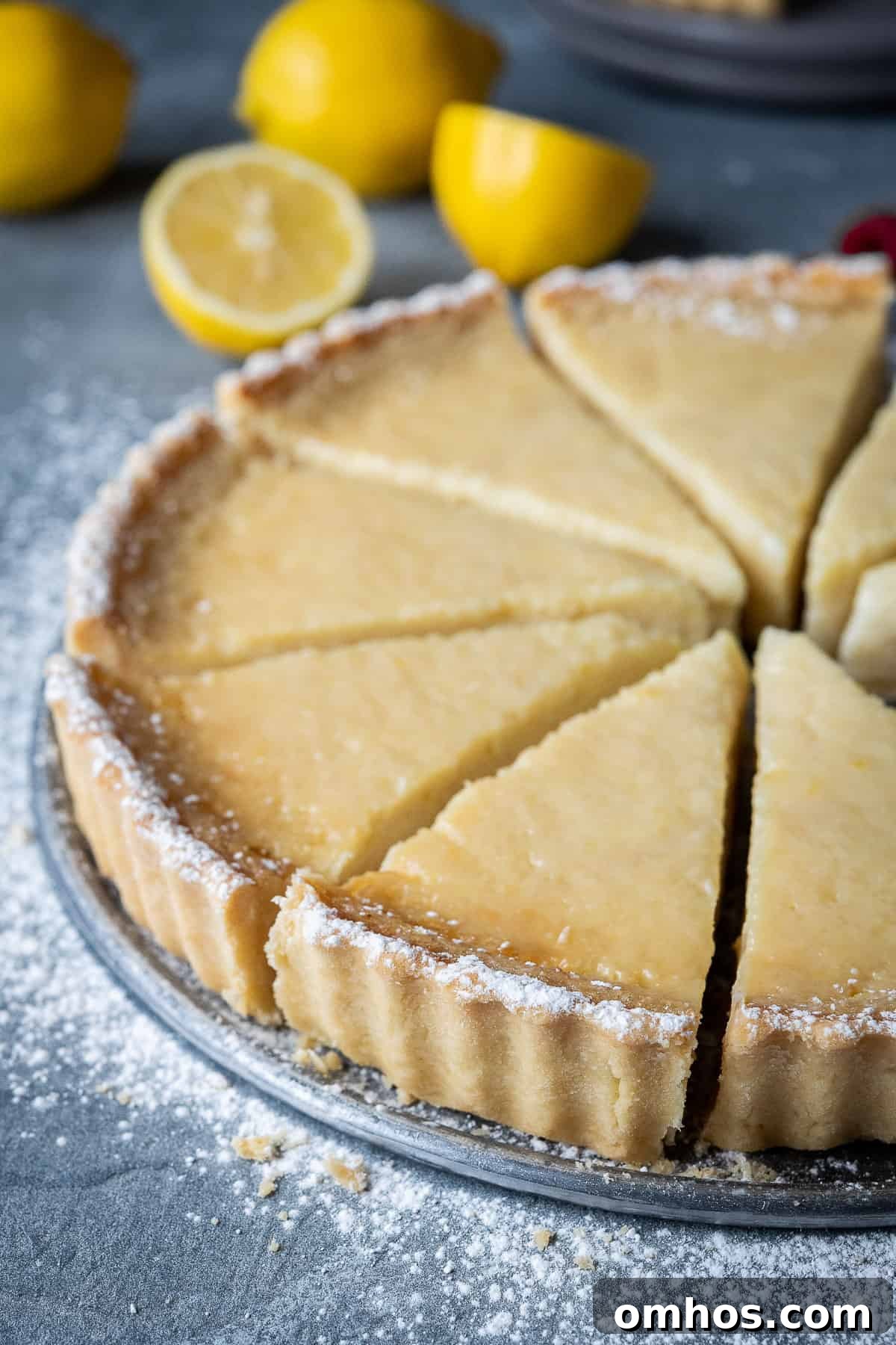 Vegan lemon tart - tangy, creamy and intensely lemony Close up of the side of a vegan lemon tart.