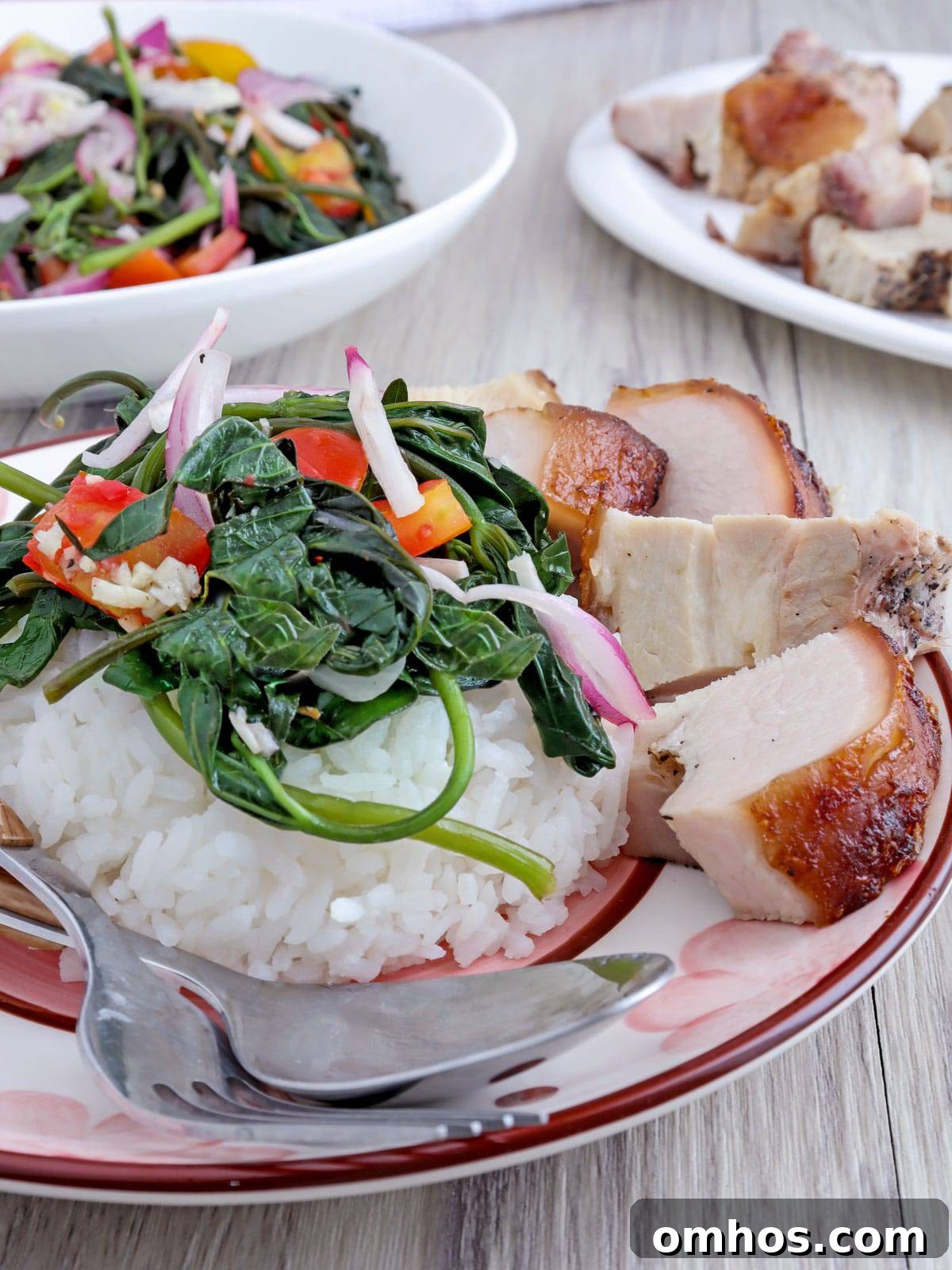kamote tops salad over steamed rice with lechon kawali on the side