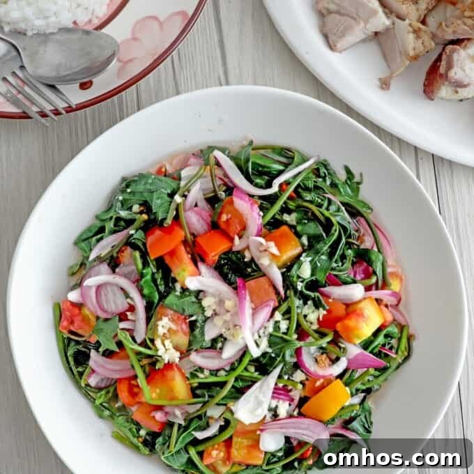 Ensaladang Talbos ng Kamote in a serving bowls with steamed rice and lechon kawali on the side