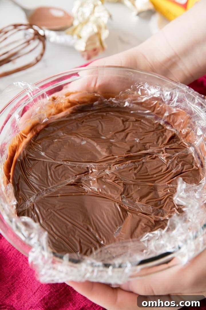Cling wrap over the surface of homemade pudding