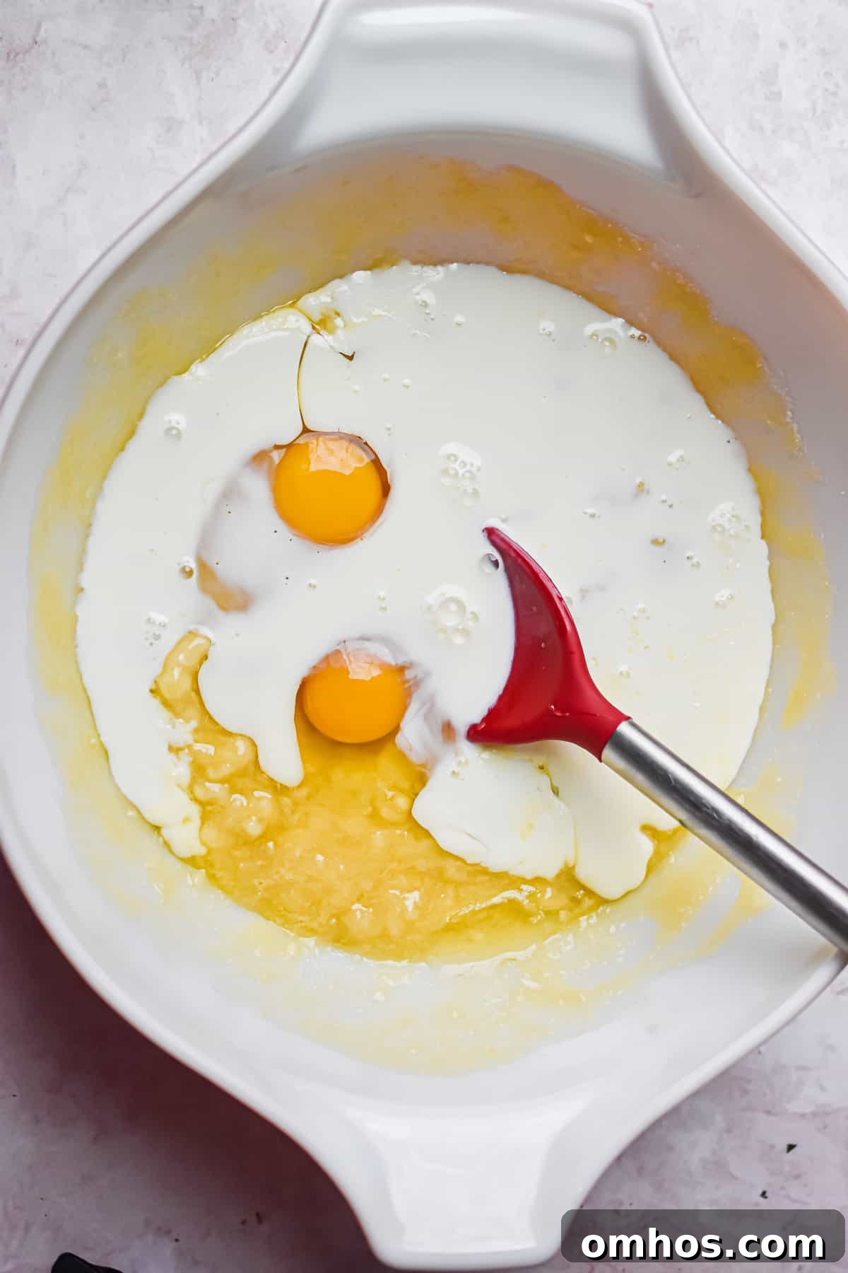 The eggs and milk are added to the bowl.