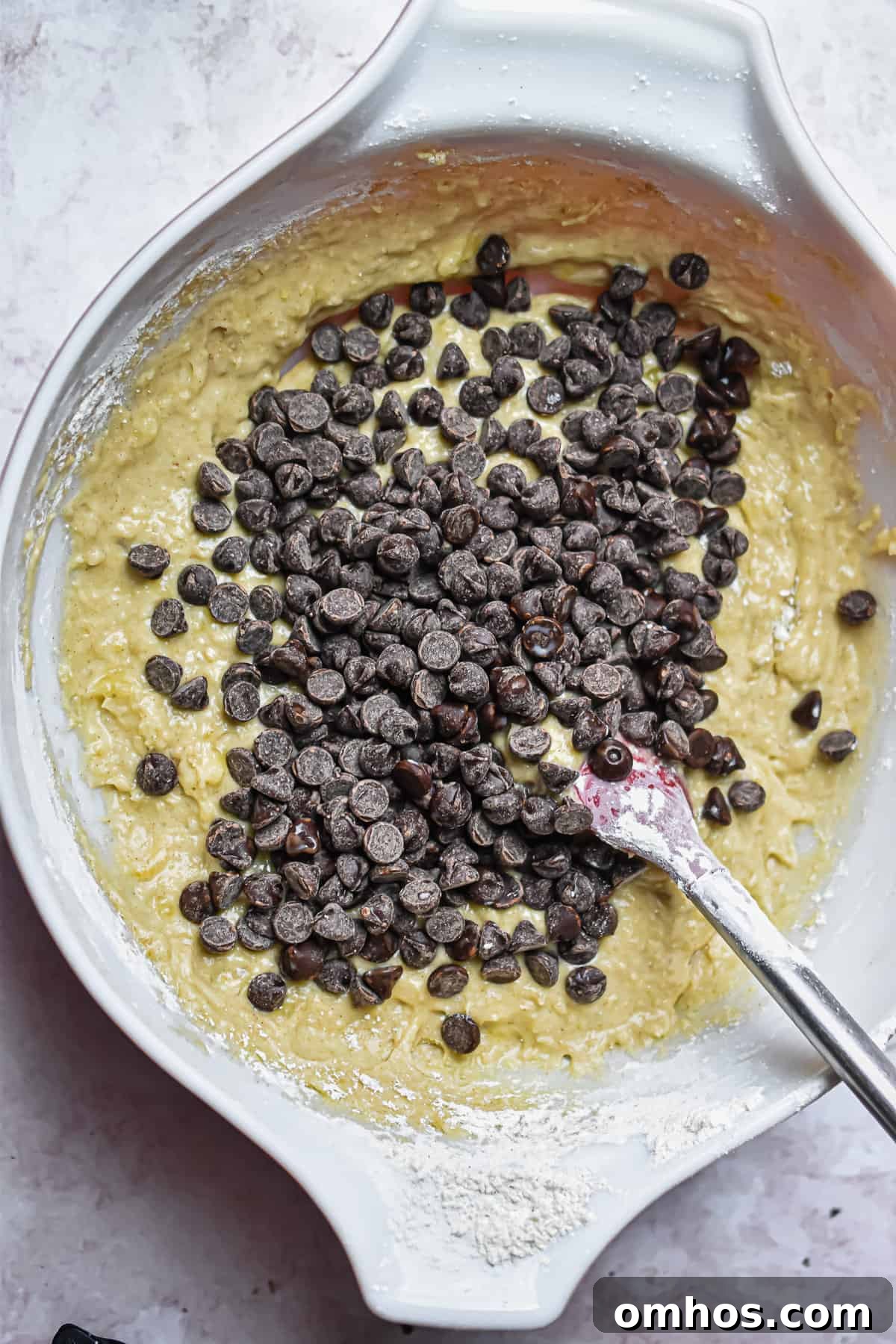 The chocolate chips are added to the bowl.