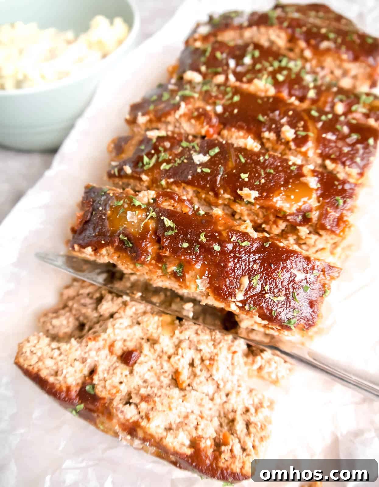 Flavorful Paleo Meatloaf Recipe: Dairy Free, Gluten Free 11 Paleo meatloaf covered in meatloaf sauce sliced and ready to serve.