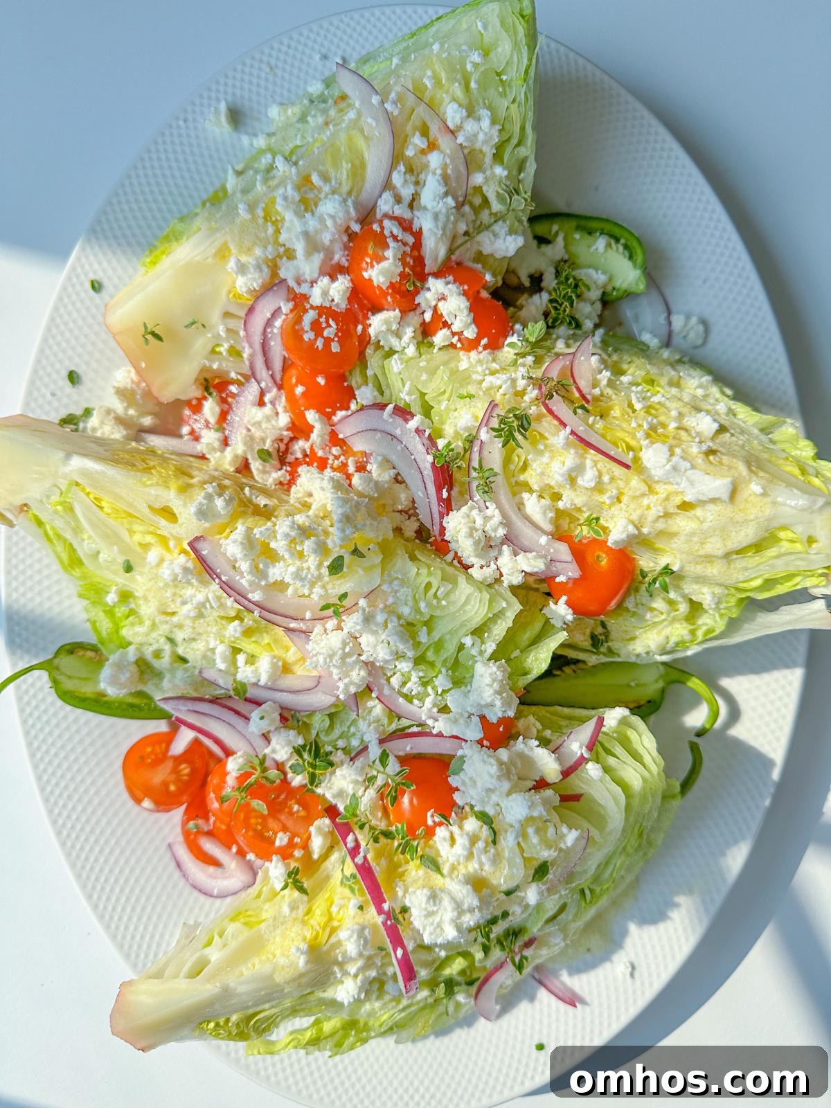 Classic Iceberg Wedge Salad with Blue Cheese and Bacon 2 Wedge salad with cherry tomatoes, red onion, and crumbled feta