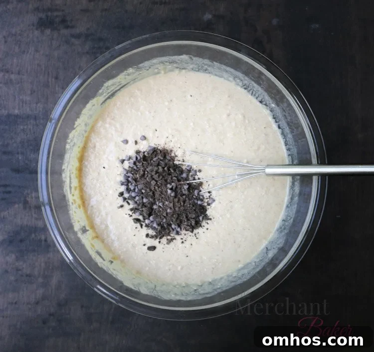 Chocolate chips being added to Oatmeal Chocolate Chip Banana Pancake Batter