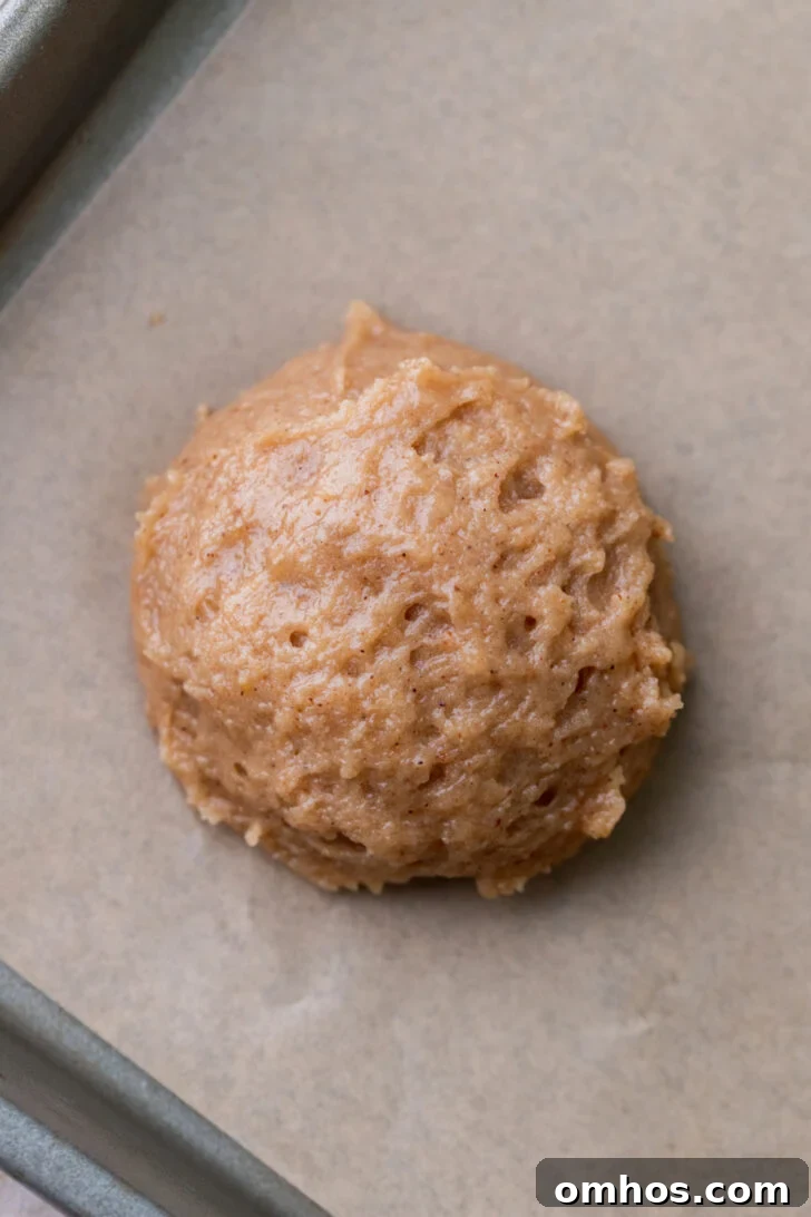 Cookie dough ball on a cookie sheet.
