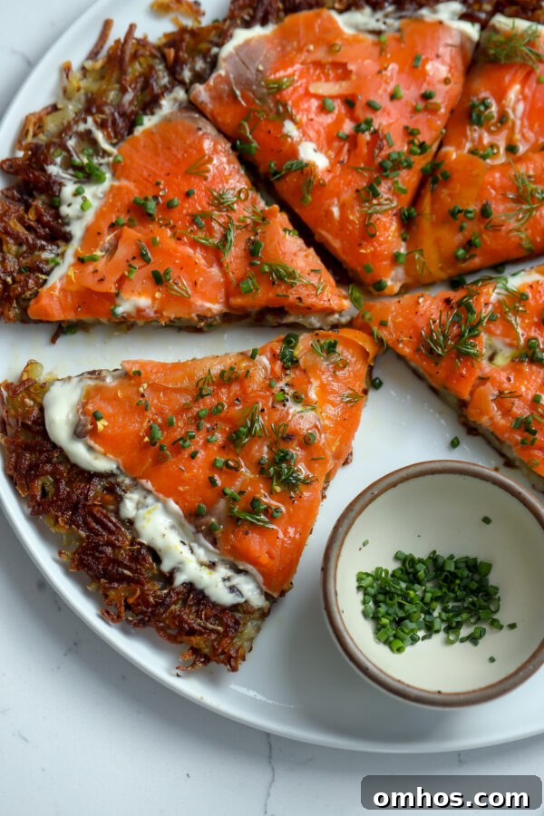 Fried pommes darphin with smoked salmon, creme friache and herbs on top as either an appetizer or a side.