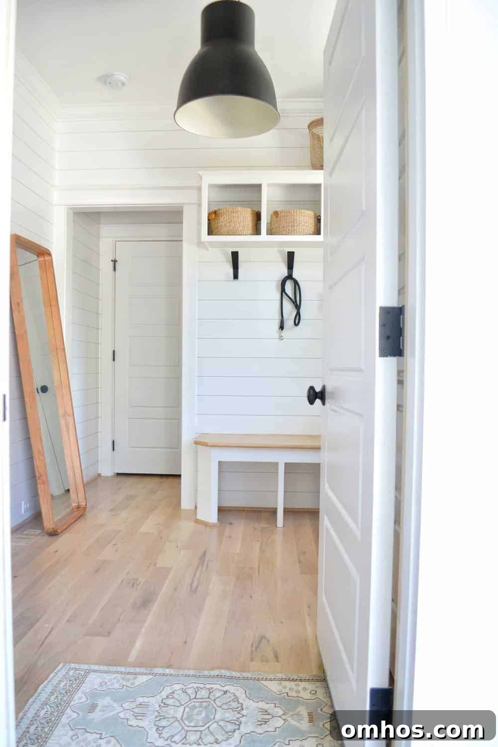 statement lighting in the organized mudroom with shoe organization