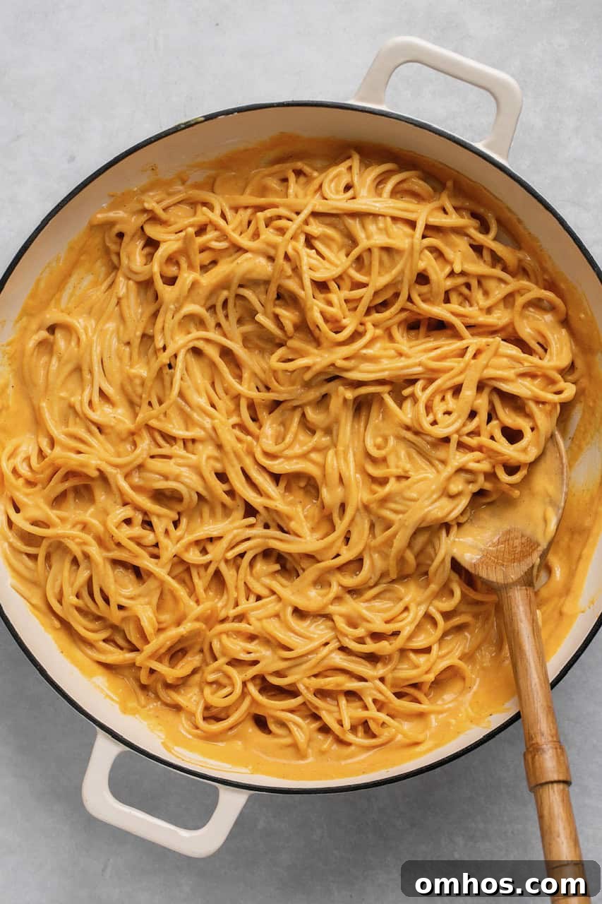Creamy Pumpkin Pasta Sauce Recipe 6 pumpkin sauce with gluten free spaghetti in a pot with wooden spoon