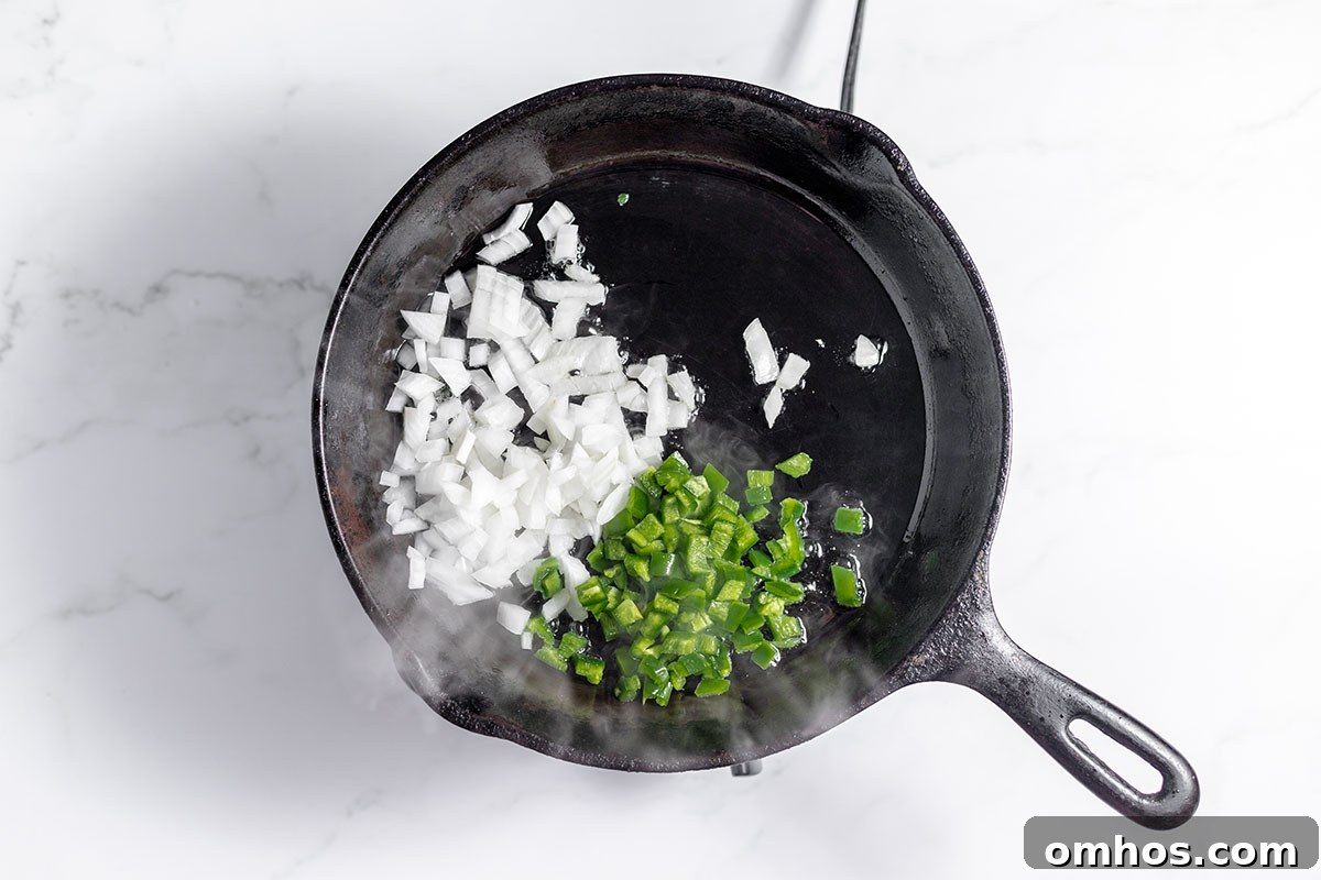 Diced jalapeno and onion in cast iron skillet.