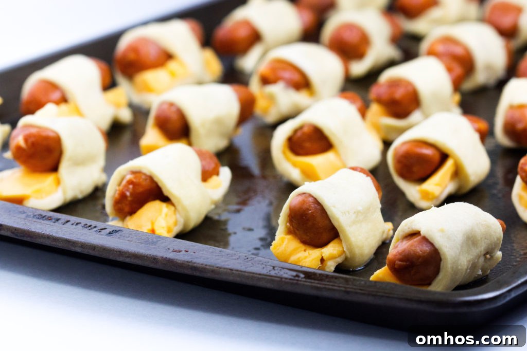 Cheesy Pigs in a Blanket Recipe: Cheese-Stuffed Sausage Bites 6 cheesy pigs in a blanket