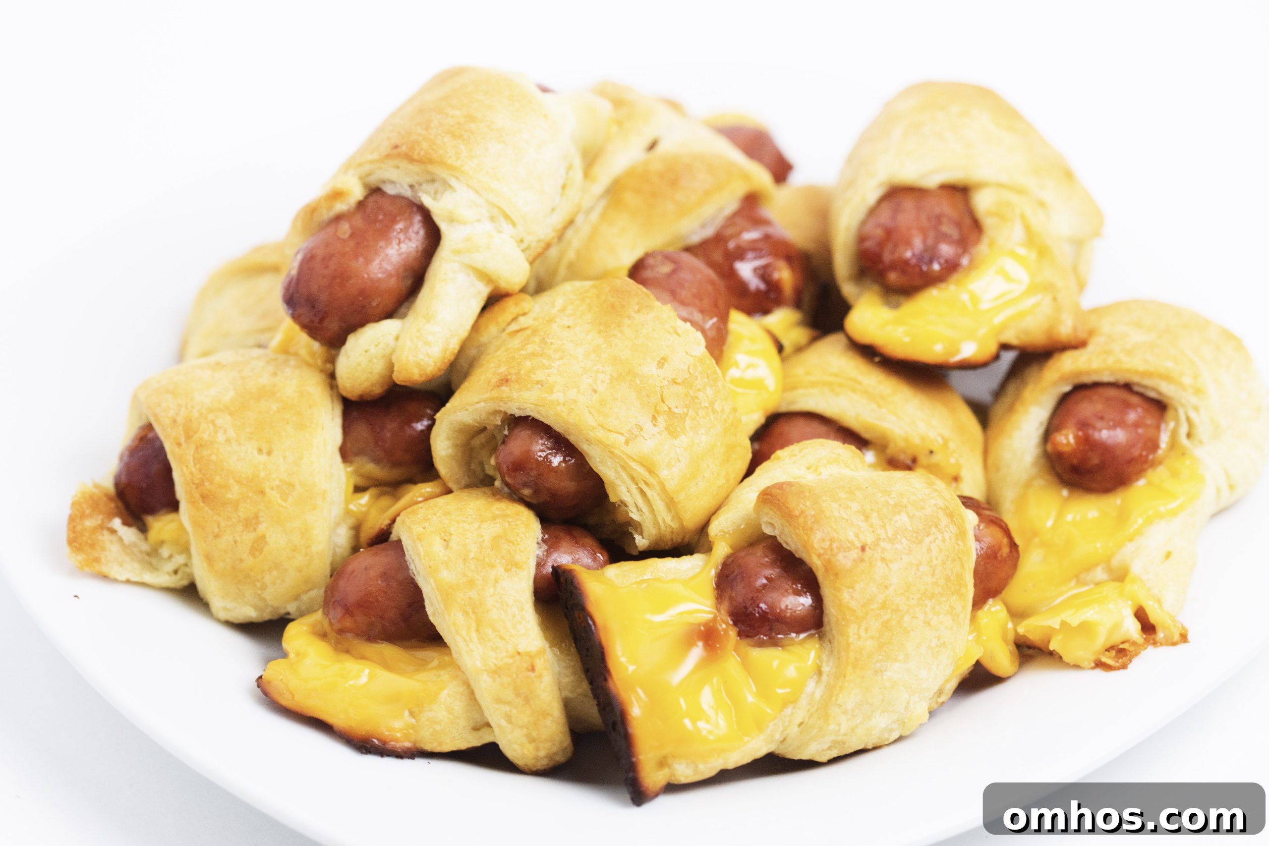 Cheesy Pigs in a Blanket Recipe: Cheese-Stuffed Sausage Bites 8 cheesy pigs in a blanket