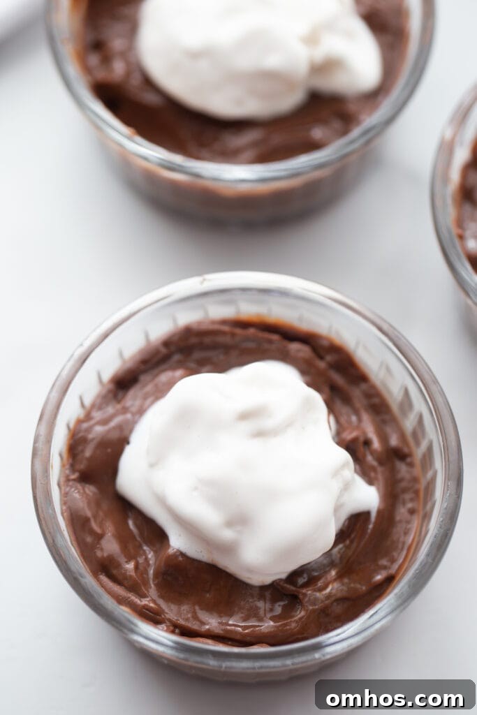 overhead shot of vegan pudding in small ramekins topped with cocowhip