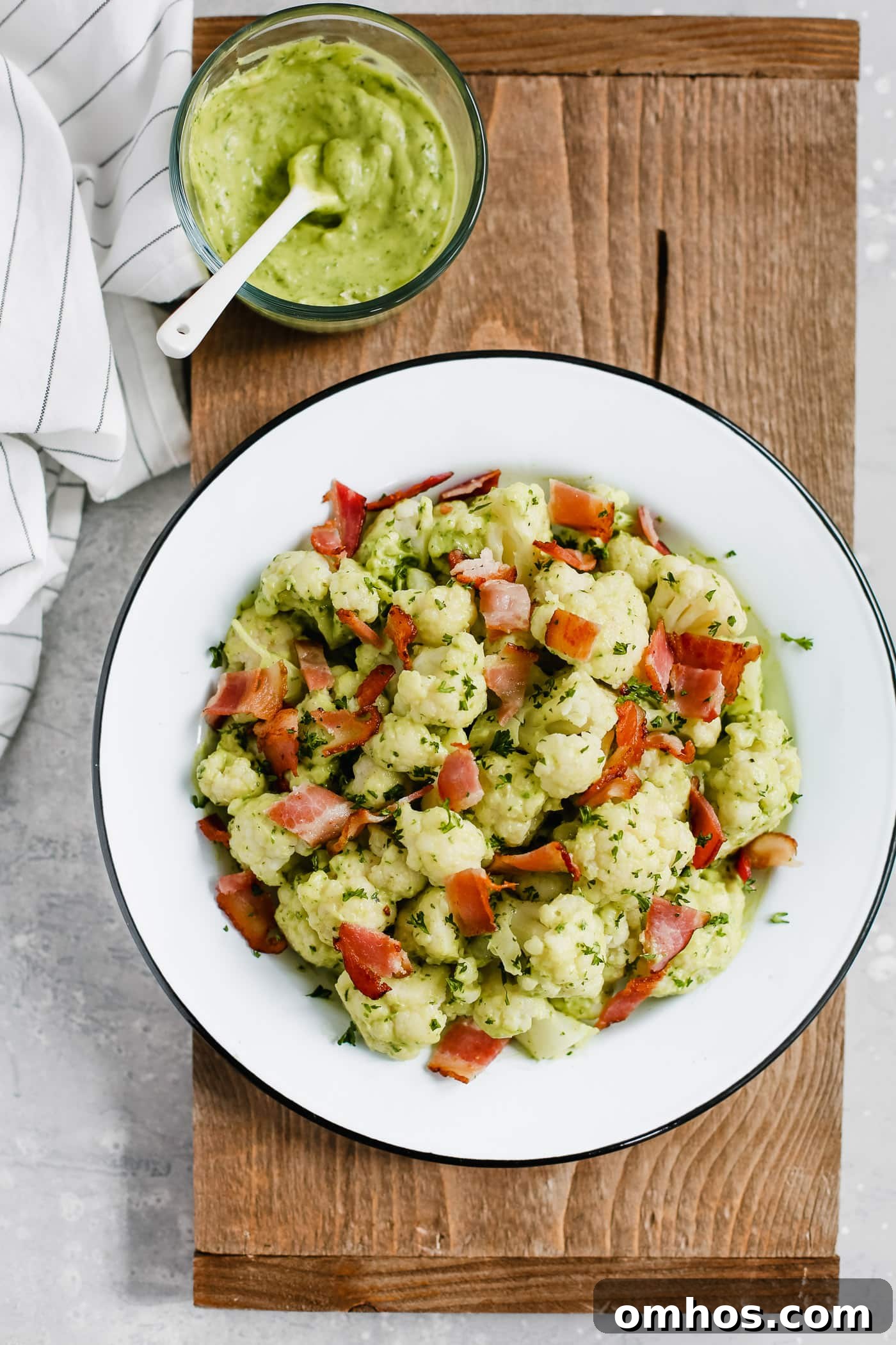 Overhead photo of a white plate of creamy avocado cauliflower salad.