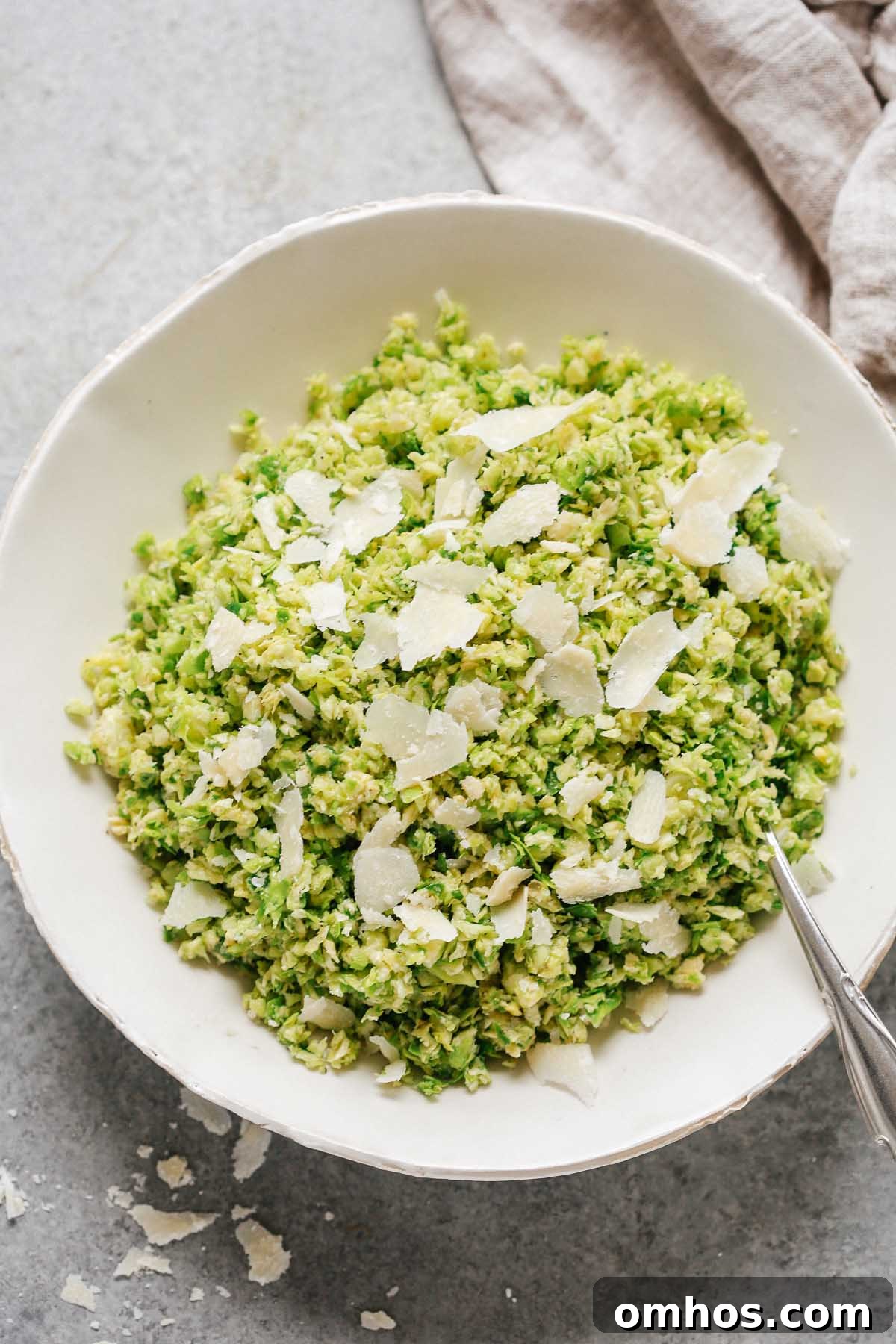 Parmesan brussels sprouts salad in a white bowl.
