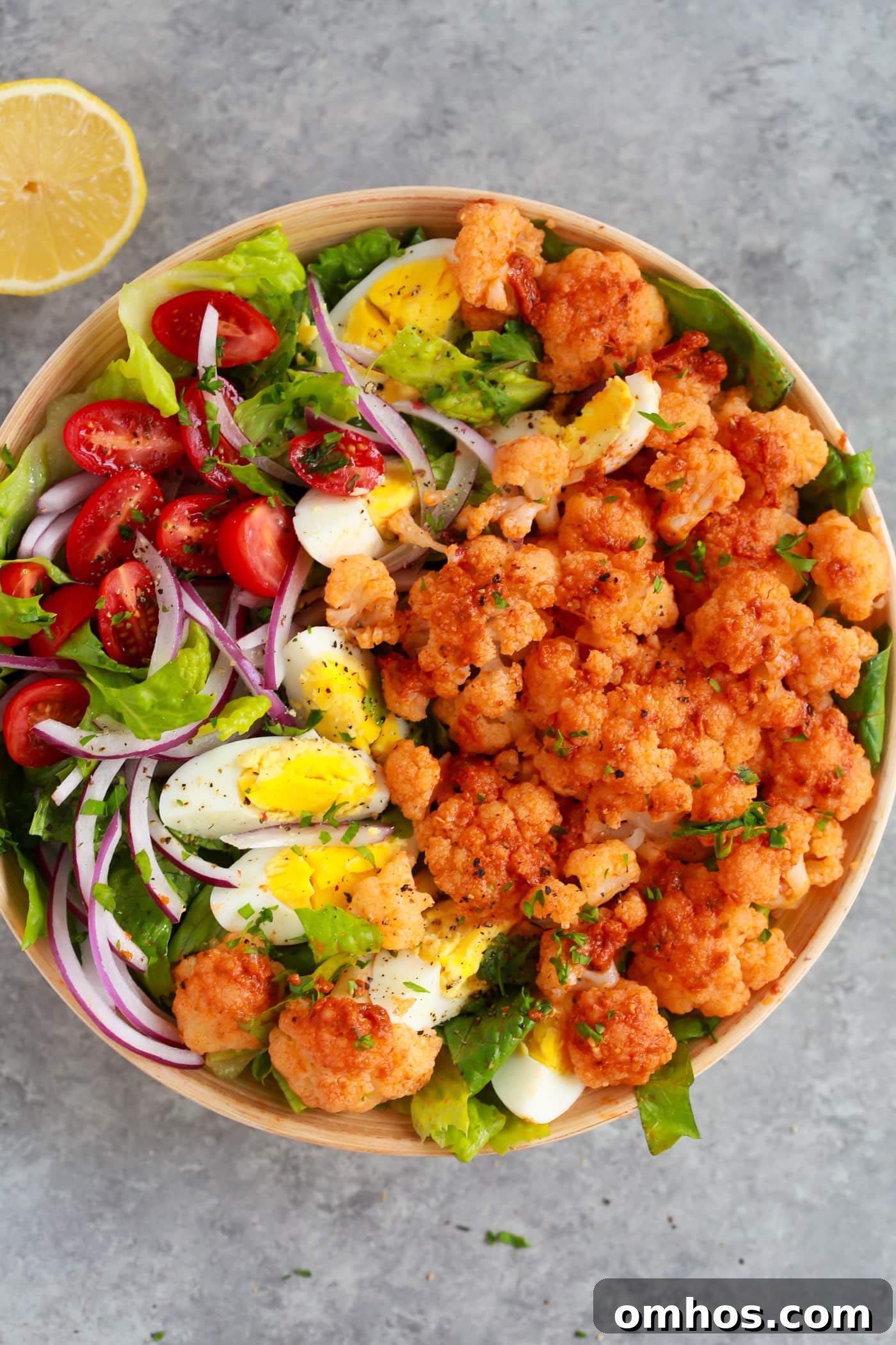 Sun-dried Tomato Pesto Cauliflower Salad on a large wooden bowl 