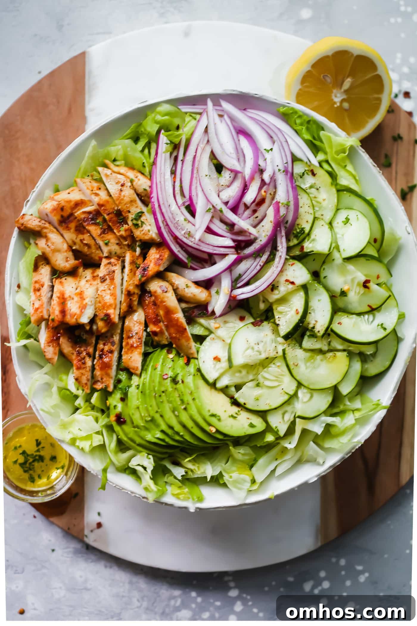 A large bowl of grilled chicken avocado salad 