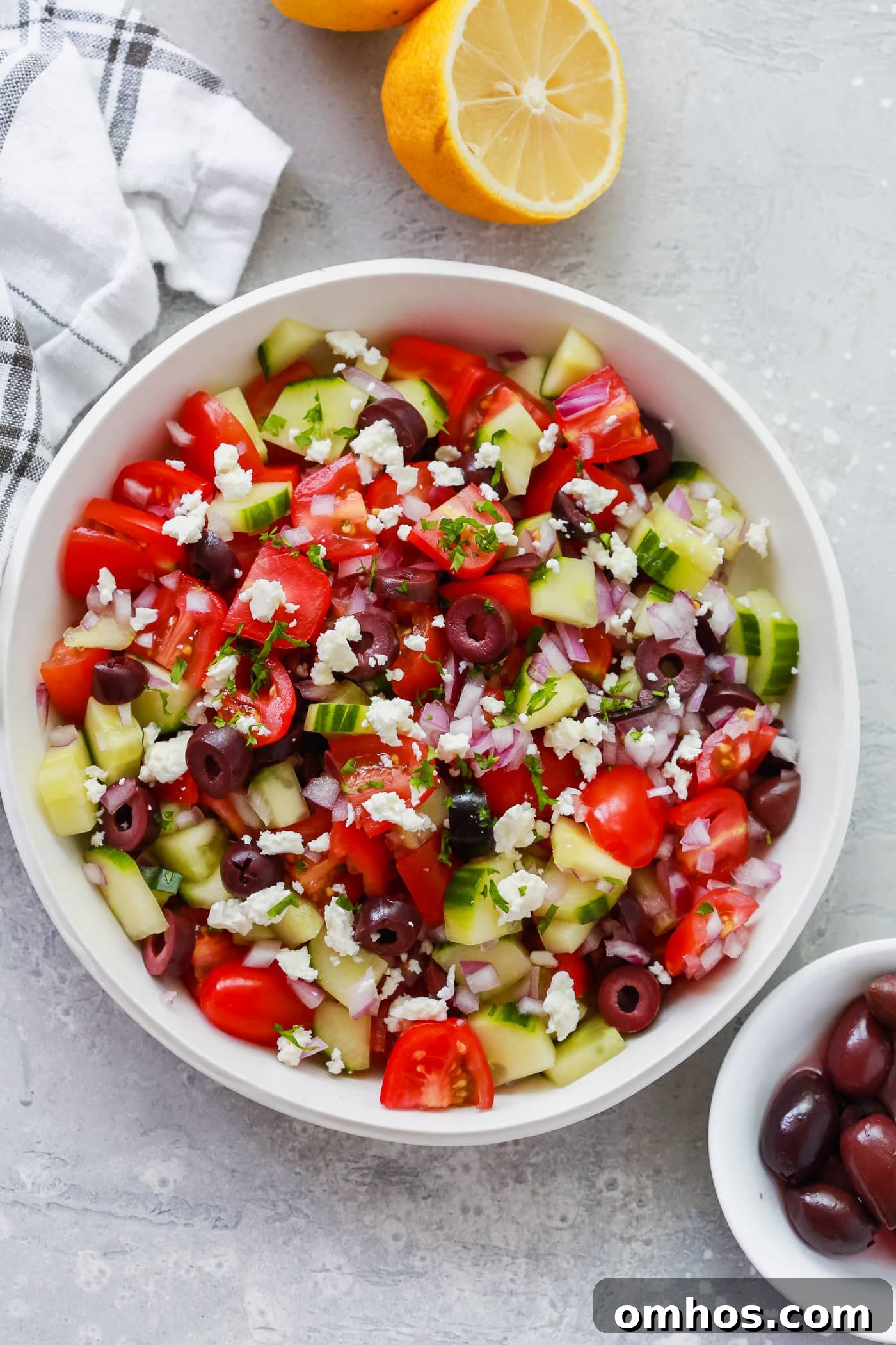 Overhead photo of a white bowl of mediterranean salad 