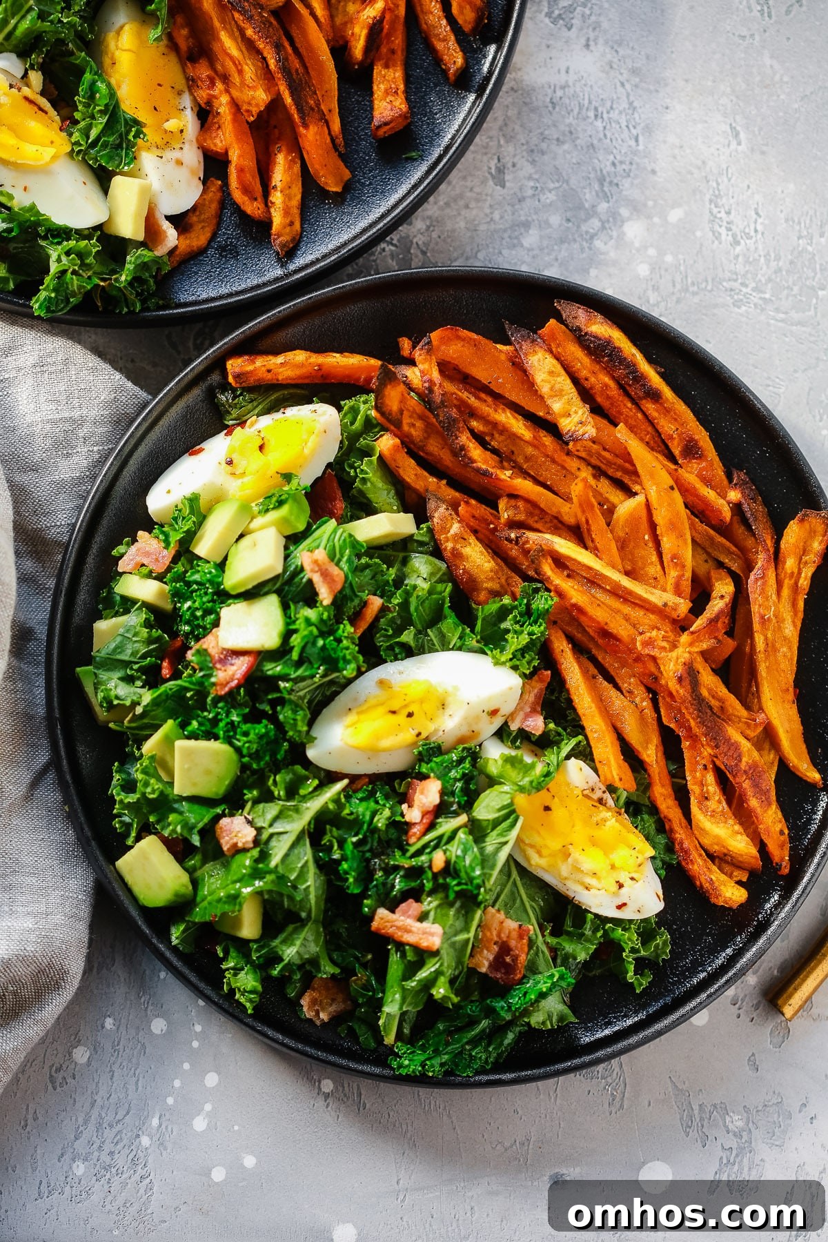 overhead view of a kale salad with sweet potato plate 